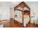 Bright main bedroom featuring a four-poster bed with elegant bedding and a beautiful chandelier at 7 W Andrews Nw Dr, Atlanta, GA 30305
