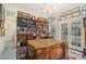 Office with floor-to-ceiling bookshelf and vintage wooden desk at 7 W Andrews Nw Dr, Atlanta, GA 30305