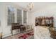 Sunlit sitting room with an antique hutch and a view of the garden at 7 W Andrews Nw Dr, Atlanta, GA 30305