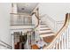 Grand staircase with hardwood steps, white railing, and view to elegant entryway at 7 W Andrews Nw Dr, Atlanta, GA 30305