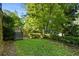 Spacious backyard with lush grass, stone steps, landscaping, and a wooden fence at 2220 Edison Ave, Atlanta, GA 30305