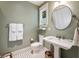 Charming bathroom featuring a pedestal sink, checkered tile floor and natural light from the window at 2220 Edison Ave, Atlanta, GA 30305