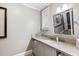 Stylish bathroom with a gray vanity, stone countertop, and framed mirror over the sink at 2220 Edison Ave, Atlanta, GA 30305