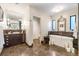 Bathroom with a soaking tub, vanity with storage, and a large, decorative mirror at 2220 Edison Ave, Atlanta, GA 30305