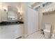 Modern bathroom with a vanity, black countertops and a tiled floor at 2220 Edison Ave, Atlanta, GA 30305