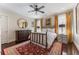 Cozy bedroom featuring a red rug, gold curtains, and ceiling fan at 2220 Edison Ave, Atlanta, GA 30305