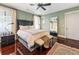 Well-lit bedroom featuring a large bed, hardwood floors, and traditional-style furnishings at 2220 Edison Ave, Atlanta, GA 30305