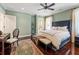 Spacious bedroom featuring hardwood floors, a ceiling fan, and views into the bathroom at 2220 Edison Ave, Atlanta, GA 30305