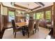 Sophisticated dining room with dark wood trim, tray ceiling, and large windows with tree views at 2220 Edison Ave, Atlanta, GA 30305