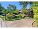 Concrete driveway leading to a charming brick home with well-manicured landscaping at 2220 Edison Ave, Atlanta, GA 30305