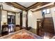 Grand foyer with beautiful wood trim, staircase, and view into other rooms at 2220 Edison Ave, Atlanta, GA 30305