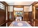 Elegant foyer featuring dark trim, hardwood floors, beautiful rugs, and large wooden front door at 2220 Edison Ave, Atlanta, GA 30305