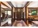 Elegant foyer with dark wood trim, hardwood floors, and a view into the dining and living rooms at 2220 Edison Ave, Atlanta, GA 30305