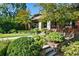 Charming brick home featuring an arched portico and lush, professionally landscaped front yard at 2220 Edison Ave, Atlanta, GA 30305