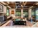 Elegant living room with coffered ceiling, fireplace, and access to outdoor spaces at 2220 Edison Ave, Atlanta, GA 30305