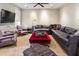 Living room featuring a large sectional couch, ceiling fan and cozy decor at 2220 Edison Ave, Atlanta, GA 30305