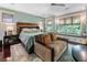 Natural light and a seating area are two highlighted features in this main bedroom space at 2220 Edison Ave, Atlanta, GA 30305