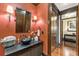 Elegant powder room with dark vanity, black bowl sink, and coral walls at 2220 Edison Ave, Atlanta, GA 30305