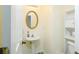 Small bathroom with pedestal sink and built-in shelving at 30 Springbottom Dr, Lawrenceville, GA 30046