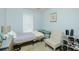 Small bedroom with a bed, chair, and shoe storage at 30 Springbottom Dr, Lawrenceville, GA 30046