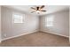 Well-lit bedroom with neutral walls, ceiling fan and carpet flooring at 3001 Scott Rd, Marietta, GA 30066