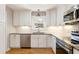 Updated kitchen, featuring white cabinets, granite counters, and stainless steel appliances at 3001 Scott Rd, Marietta, GA 30066