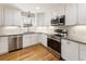 Modern kitchen with white shaker cabinets, granite countertops, and stainless steel appliances at 3001 Scott Rd, Marietta, GA 30066