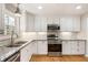 Modern kitchen with white cabinets, granite countertops and stainless steel appliances at 3001 Scott Rd, Marietta, GA 30066