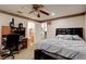 Main bedroom with ceiling fan, en-suite bathroom access, and ample closet space at 4321 Orchard Park Ct, Stone Mountain, GA 30083