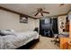 Spacious bedroom with ceiling fan, large TV, and carpeted floor at 4321 Orchard Park Ct, Stone Mountain, GA 30083