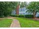 Condo building exterior showcasing a walkway and manicured lawn at 4321 Orchard Park Ct, Stone Mountain, GA 30083