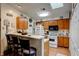 Galley kitchen with light wood cabinets and breakfast bar at 4321 Orchard Park Ct, Stone Mountain, GA 30083