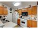 Bright kitchen with wood cabinets, white appliances, and ample counter space at 4321 Orchard Park Ct, Stone Mountain, GA 30083