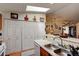 Kitchen features a skylight, white cabinets, and a pass-through to the dining area at 4321 Orchard Park Ct, Stone Mountain, GA 30083