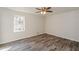 Bedroom showcasing stylish wood floors, ample natural light, and a modern ceiling fan at 3667 Humphries Hill Rd, Austell, GA 30106