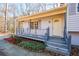 Inviting covered front porch with a unique gray-blue railing welcomes you to the home at 3667 Humphries Hill Rd, Austell, GA 30106