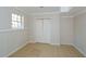 Neutral room with light walls and a window next to a closet with double doors and tile floor at 3667 Humphries Hill Rd, Austell, GA 30106