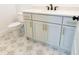 Modern bathroom with light gray vanity and star patterned floor at 6565 Rhett Run, Cumming, GA 30028