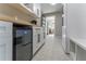 Laundry room with built-in storage, beverage fridge and patterned tile floor at 6856 Womack Ct, Peachtree Corners, GA 30360