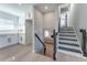 Modern staircase with black railing and light wood floors at 6856 Womack Ct, Peachtree Corners, GA 30360