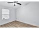 Well-lit bedroom featuring wood-look flooring and a ceiling fan at 2918 Fields Dr, Lithonia, GA 30038