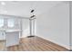 Modern dining room with light hardwood floors and pendant lighting at 2918 Fields Dr, Lithonia, GA 30038