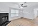 Bright living room with fireplace, hardwood floors, and ceiling fan at 2918 Fields Dr, Lithonia, GA 30038