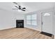 Bright living room with fireplace, hardwood floors, and ceiling fan at 2918 Fields Dr, Lithonia, GA 30038