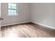 Bright bedroom featuring wood-look flooring and a window at 3589 Satellite Blvd, Ellenwood, GA 30294