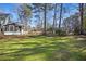 A lovely green backyard with a patio and lush perimeter landscaping at 450 Surveyors Pt, Suwanee, GA 30024