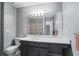 Bathroom with gray walls, gray cabinets, a large mirror, and a white sink with a bathtub and shower at 450 Surveyors Pt, Suwanee, GA 30024