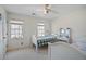 Bedroom with white walls, two twin beds, a ceiling fan and natural light from the large windows at 450 Surveyors Pt, Suwanee, GA 30024