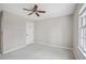 Bedroom featuring a ceiling fan, neutral carpeting, white walls, and a single window for natural light at 450 Surveyors Pt, Suwanee, GA 30024