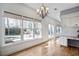 Sunny dining area with hardwood floors, modern chandelier, and bright natural light at 450 Surveyors Pt, Suwanee, GA 30024